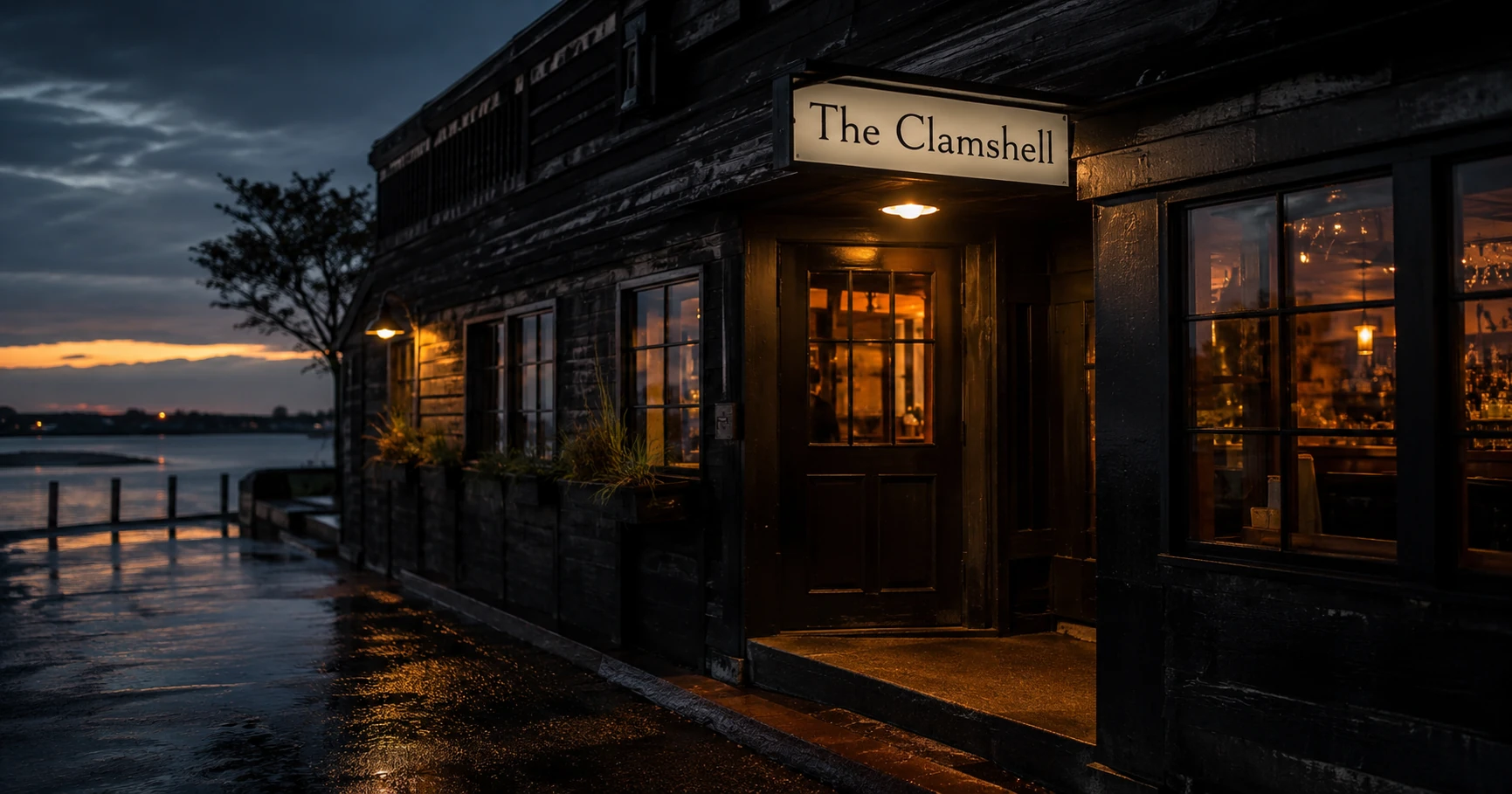 Exterior of The Clamshell at dusk with amber doorway light